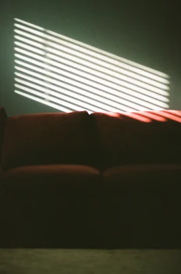 sunlight through blinds on person's torso