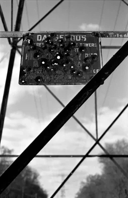 weathered sign on electrical tower structure