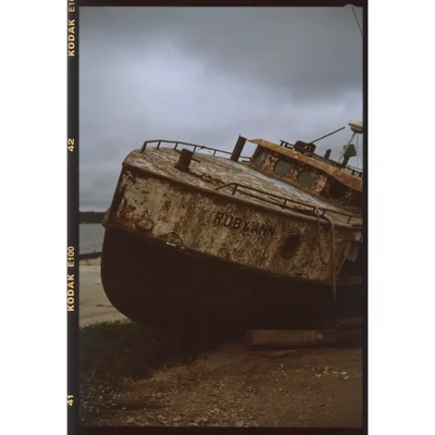 rusted abandoned boat on shore