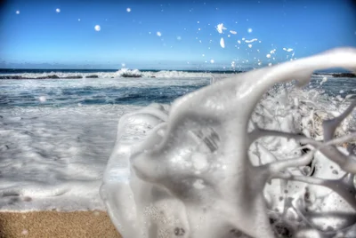 milk splash on beach with ocean waves