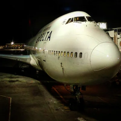 delta boeing 747 parked at night gate