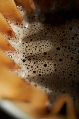 coffee foam with bubbles in wooden cup