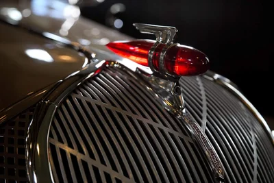 vintage car grille with red hood ornament