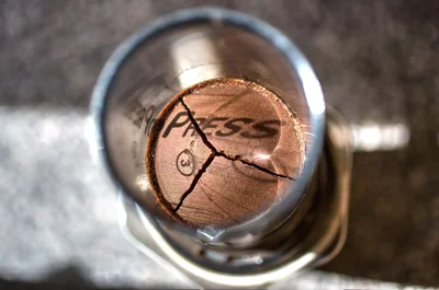 damaged penny viewed through magnifying glass